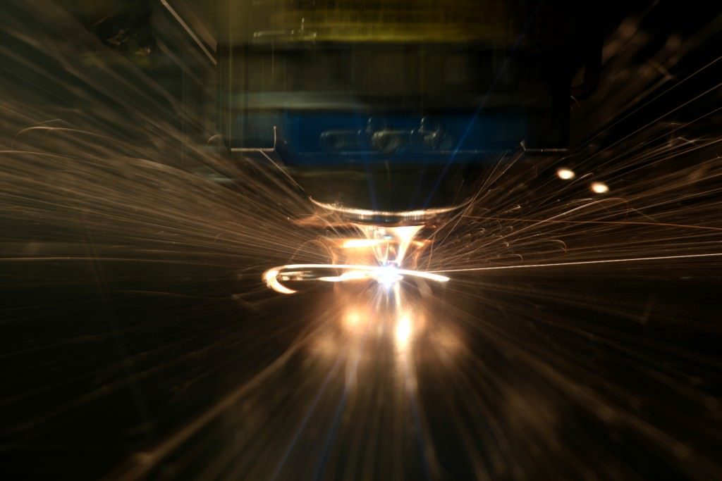 A close up of laser cutting small details in steel