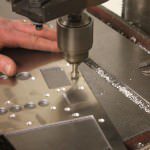 The countersinking of metal panels